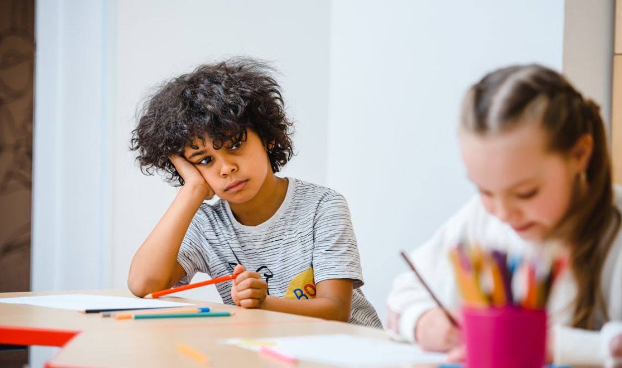 Boy Leaning on Desk
