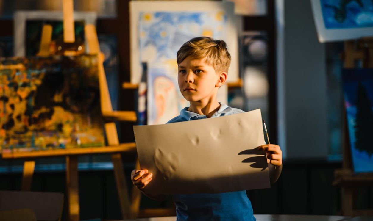Boy Holding a Paper