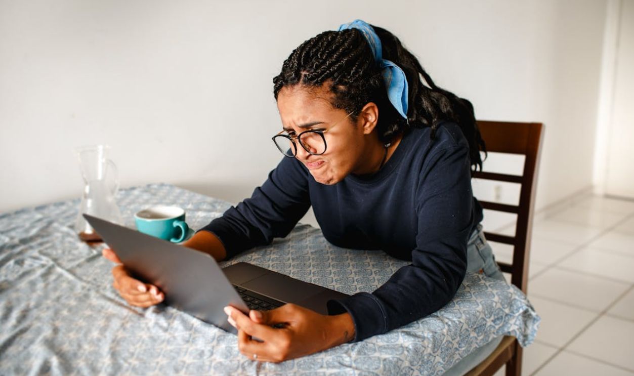 Frustrated Woman Looking at Laptop Screen Indoors