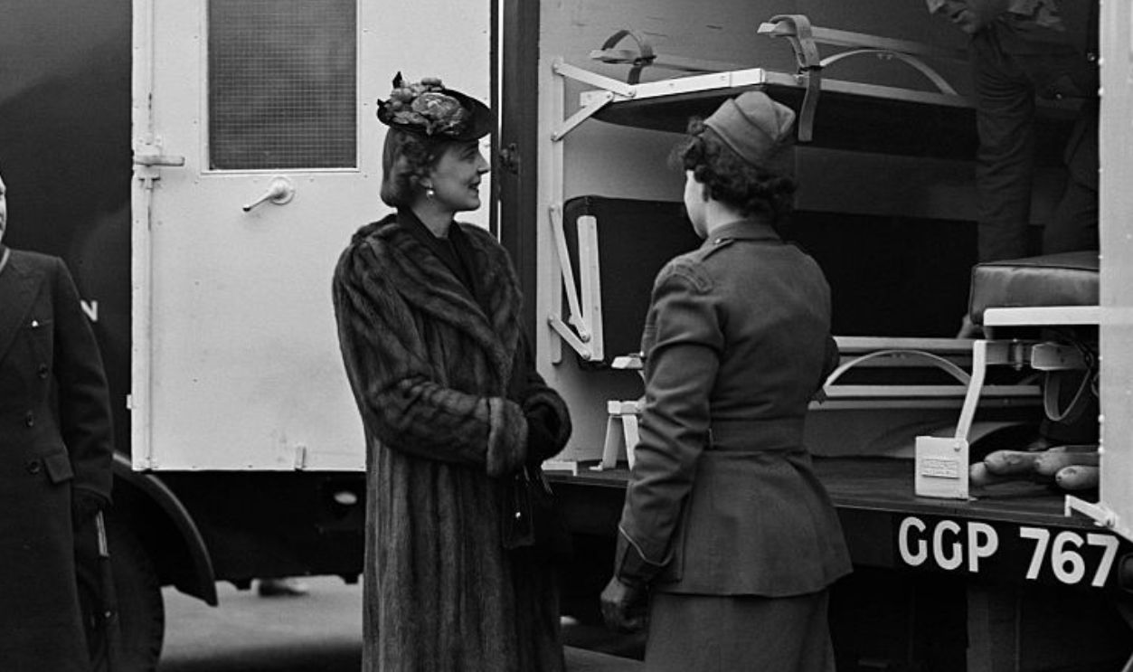 A member of the First Aid Nursing Yeomanry (Princess Royal's Volunteer Corps - FANY) with Princess Marina of Greece and Denmark inspecting an ambulance, presented by a British organisation, before handing it over to the representative of the Greek Government, London, UK, 12th February 1941.