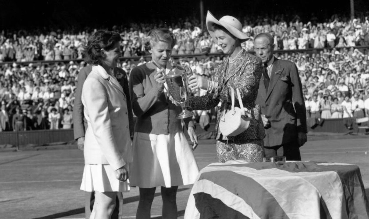 2nd July 1949: Margaret du Pont (nee Osborne) of the USA (left) and Louise Brough of the USA collecting the Women's Doubles Trophy from the Duchess of Kent after beating Gussie Moran and Pat Todd at the Wimbledon Lawn Tennis Championships.