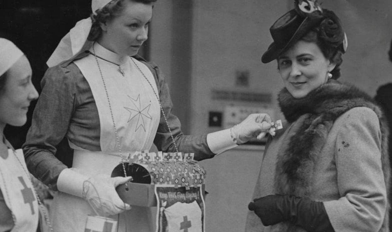 Marina Duchess of Kent buys a flag from fundraisers on British Red Cross and St. John's flag day.
