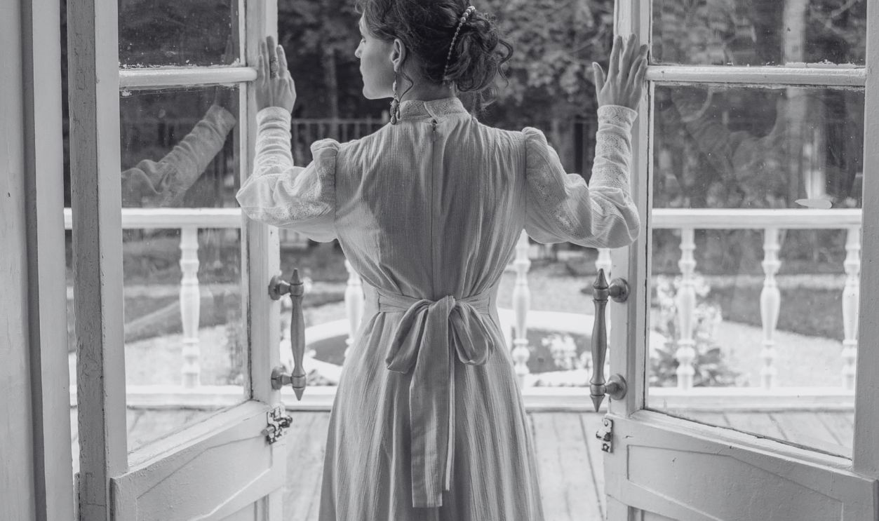 Woman in White Dress Standing Beside Doors