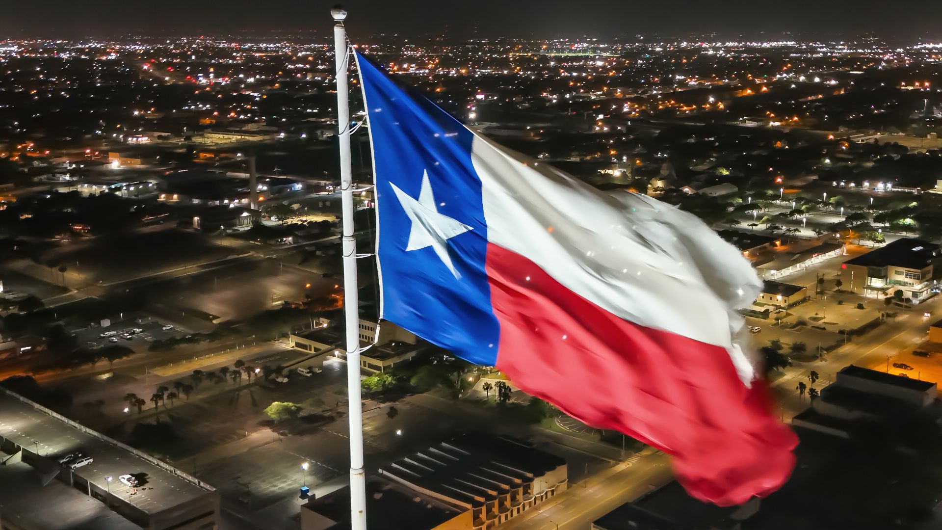 Flag of Texas waving above Corpus Christi