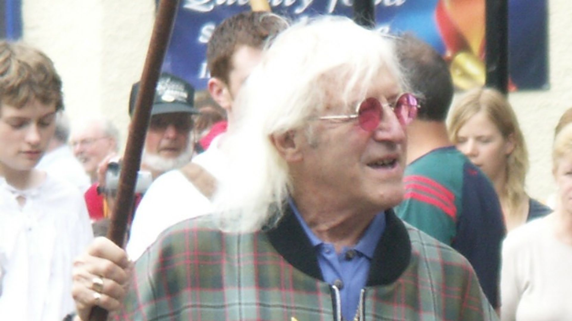 Sir Jimmy Savile

Leading the pipe band through Fort William to the en:Lochaber en:Highland Games in his capacity as Honorary en:Chieftain of the games.   This was taken on Saturday 29th July 2006, Sir Jimmy Savile recorded the final edition of en:Top of the Pops during the week rather than take part in a live broadcast on Sunday because of his commitment to the Lochaber Highland Games.  He announced that he was stepping down from being Honorary Chieftain but would continue to be a
