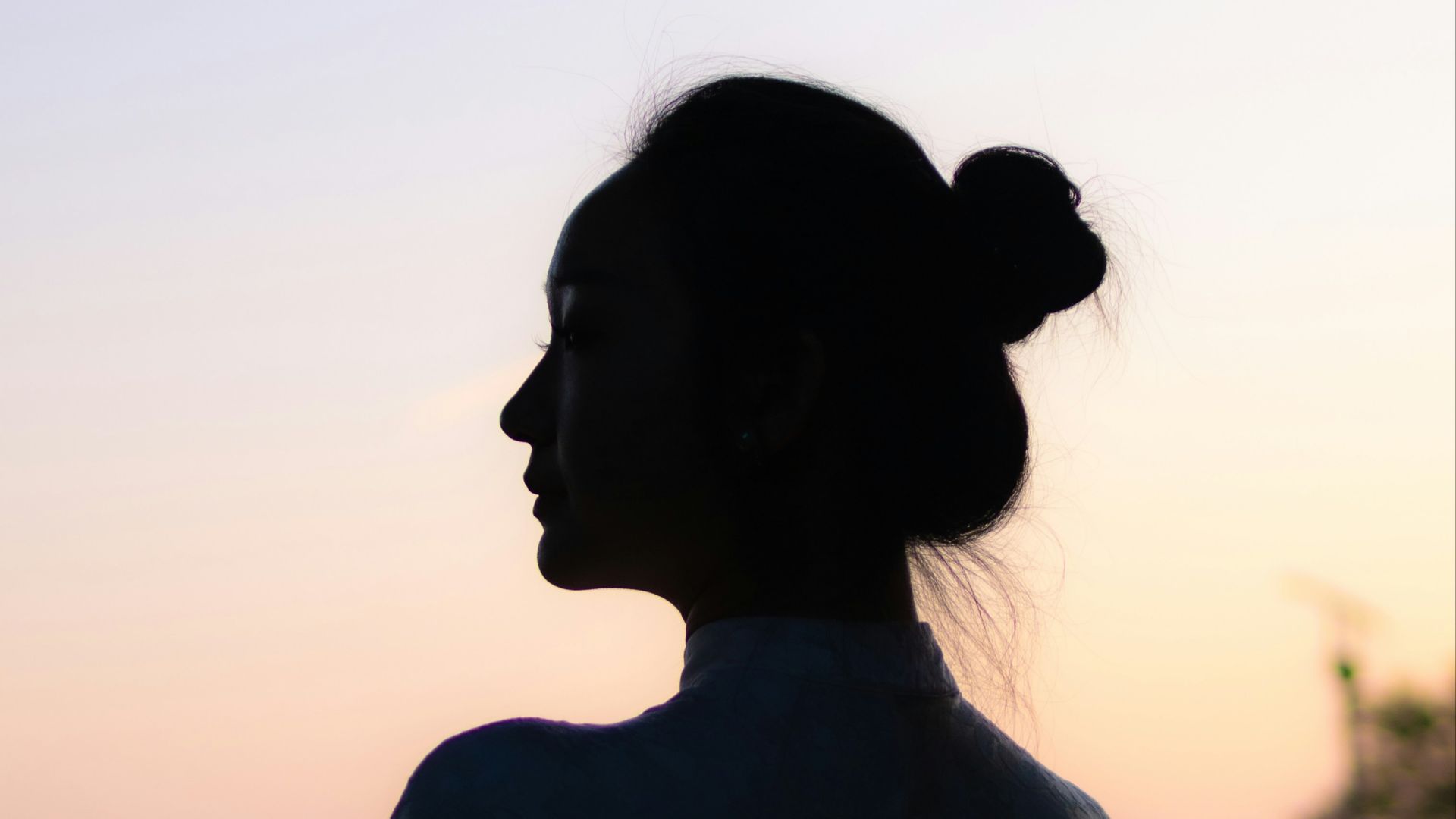 A woman's silhouette against the sunset.