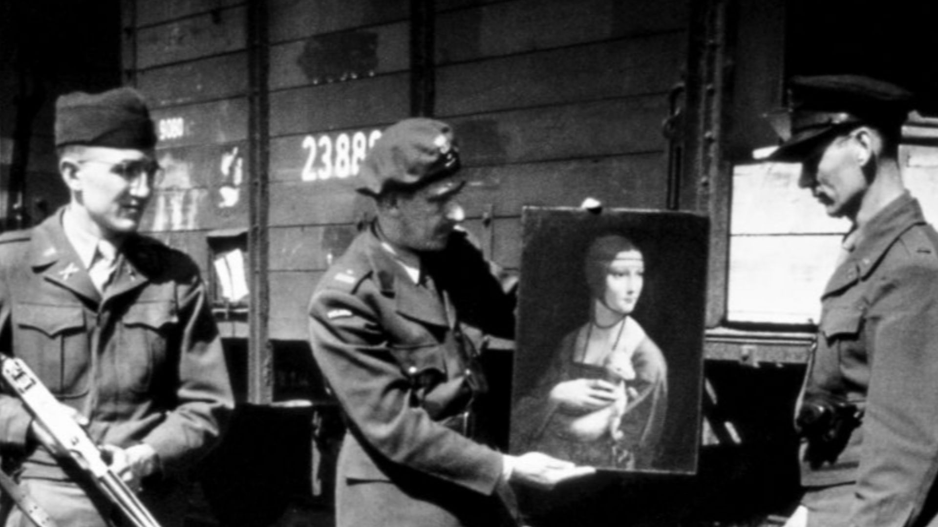 Monuments Man Lt. Frank P. Albright, Polish Liaison Officer Maj. Karol Estreicher, Monuments Man Capt. Everett Parker Lesley, and Pfc. Joe D. Espinosa, guard with the 34th Field Artillery Battalion, pose with Leonardo
da Vinci's Lady with an Ermine upon its return to Poland in April 1946.