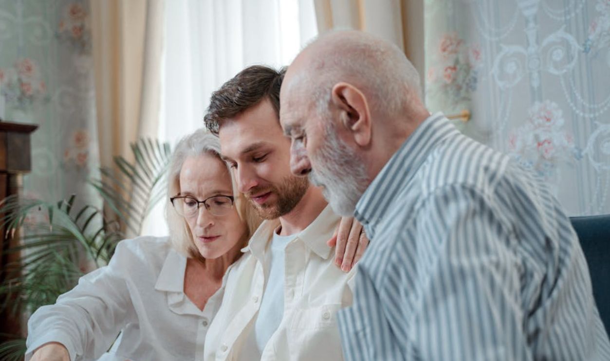 A family cherishing memories by browsing a photo album together indoors