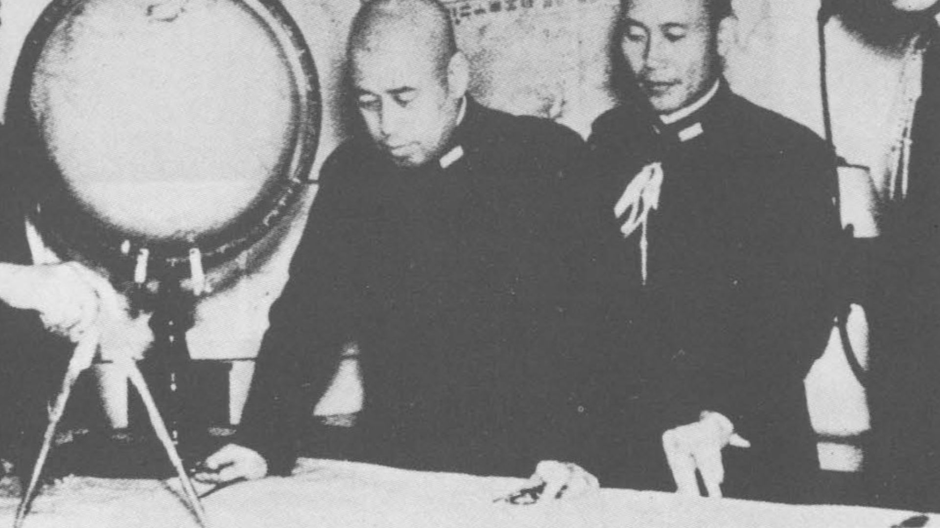 Imperial Japanese Navy Admiral Isoroku Yamamoto (center, bending over table) with (from left) Chief of Staff Matome Ugaki, liaison staff officer Shigero Fujii, and administrative officer Yasuji Watanabe.  Photographed on battleship Nagato sometime in 1940.