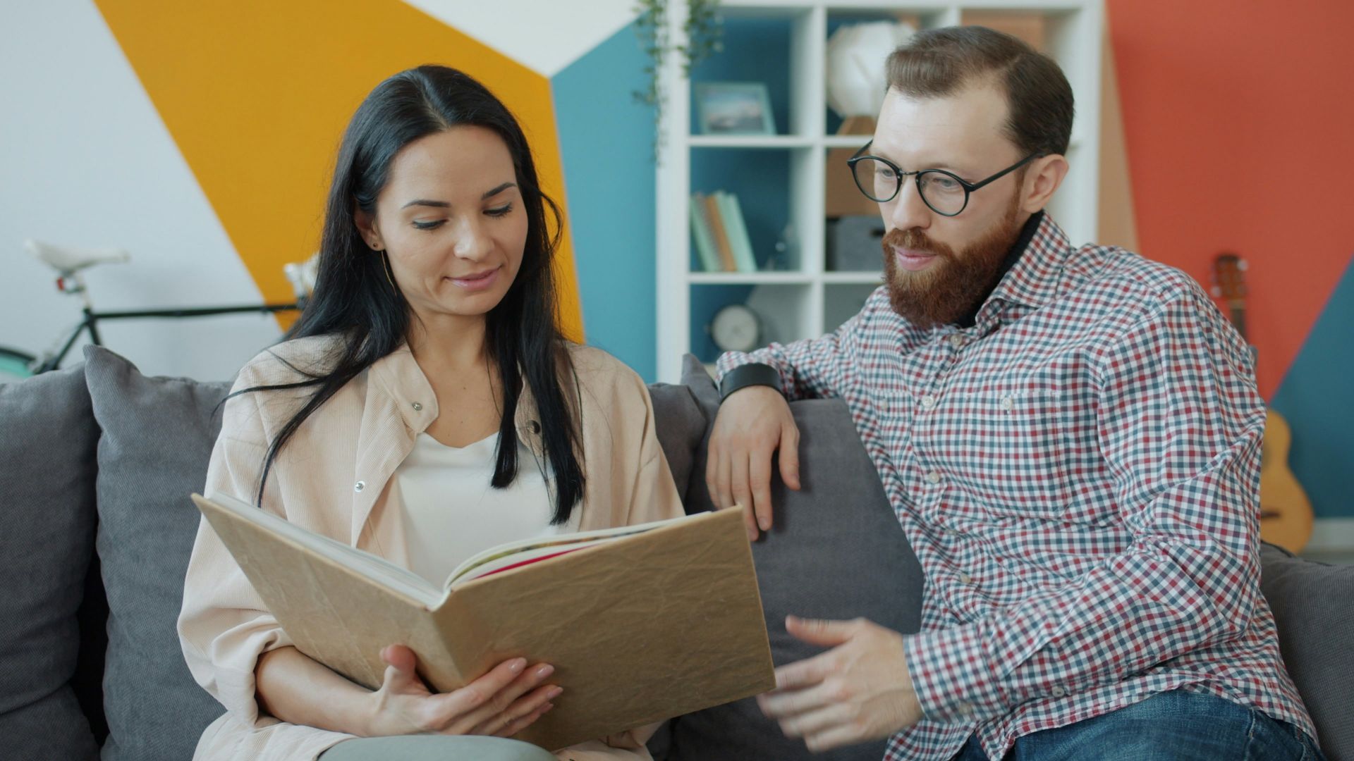 Couple looking at an open photo album together