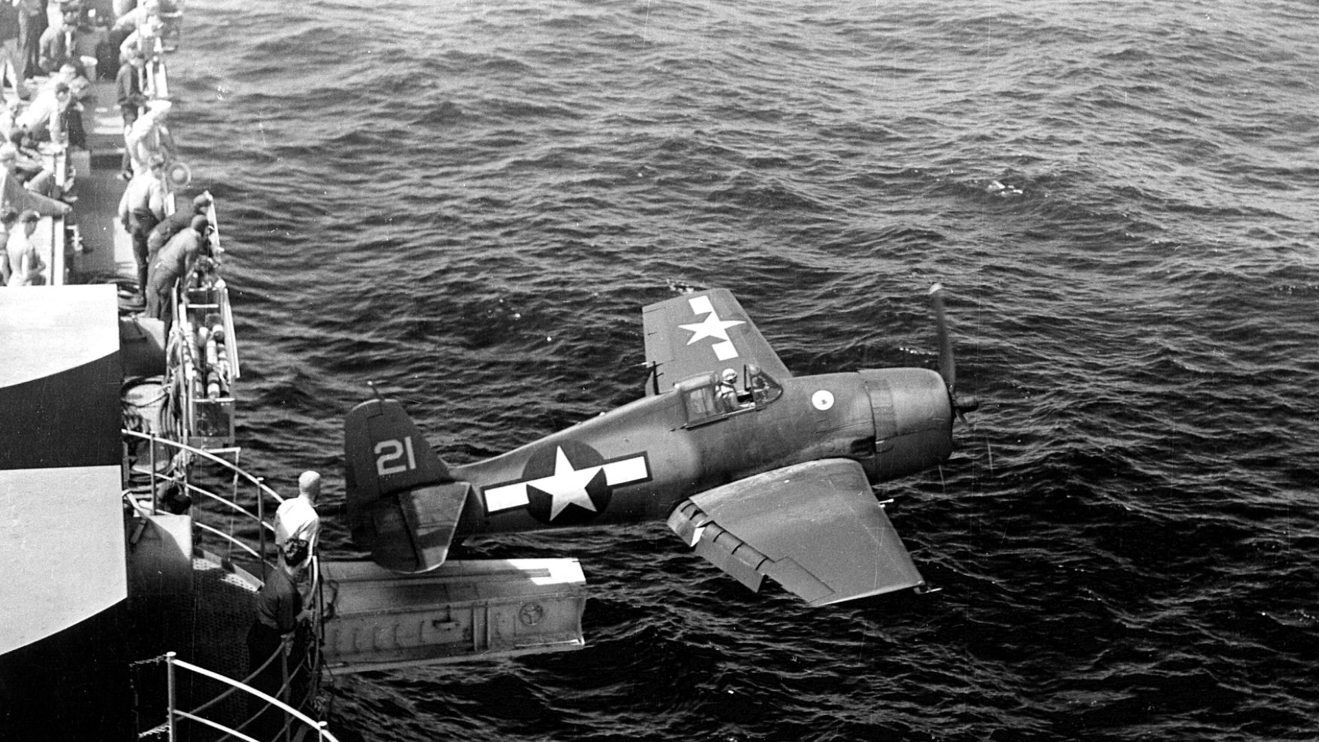 A U.S. Navy Grumman F6F-3 Hellcat fighter of fighting squadron VF-15 being catapulted from the aircraft carrier USS Hornet (CV-12) via the hangar catapult, 25 February 1944.