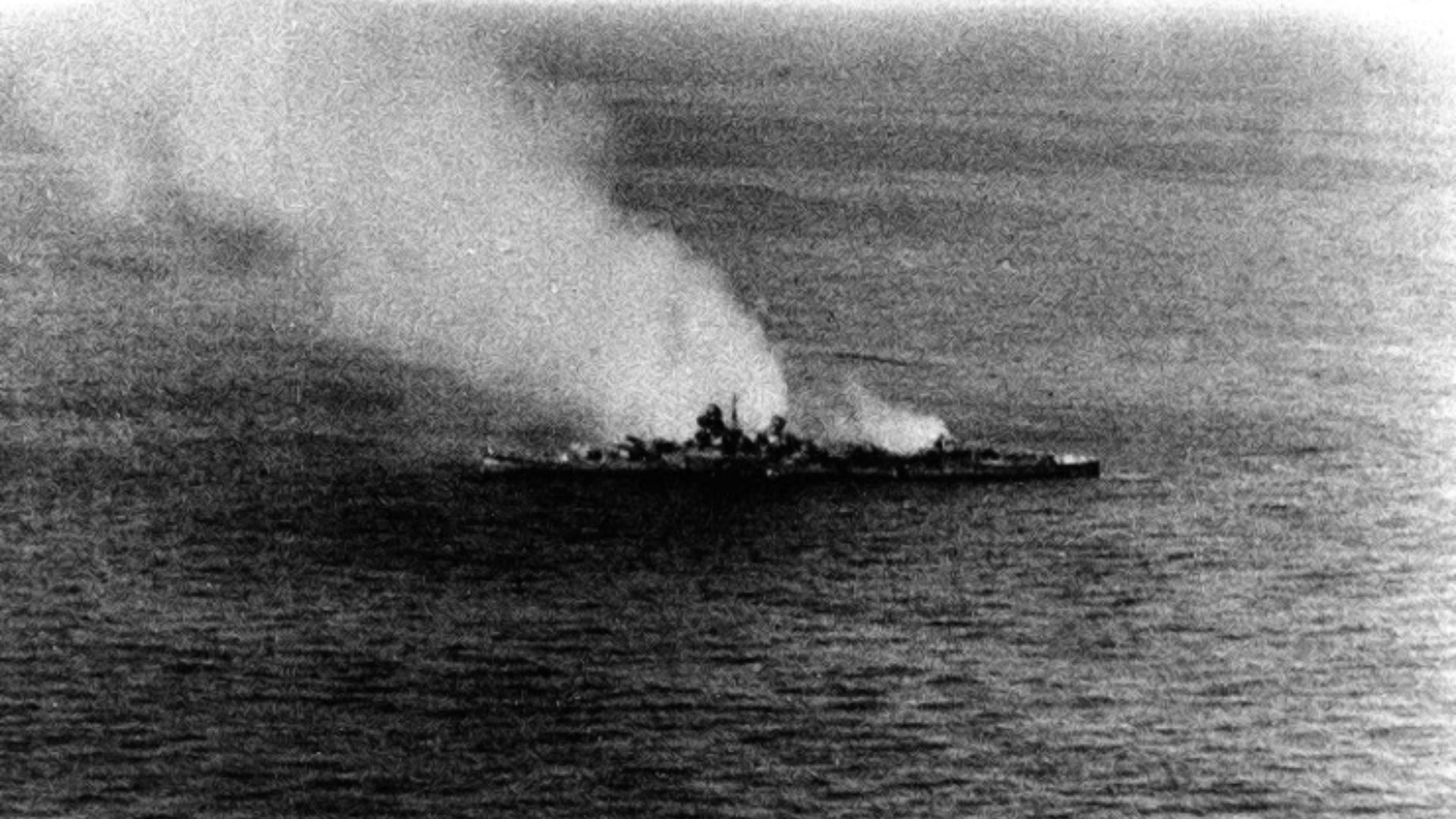 The Japanese heavy cruiser Mikuma dead in the water and burning, following attacks by U.S. Navy Douglas SBD-3 Dauntless planes from the aircraft carriers USS Enterprise (CV-6) and USS Hornet (CV-8), 6 June 1942.