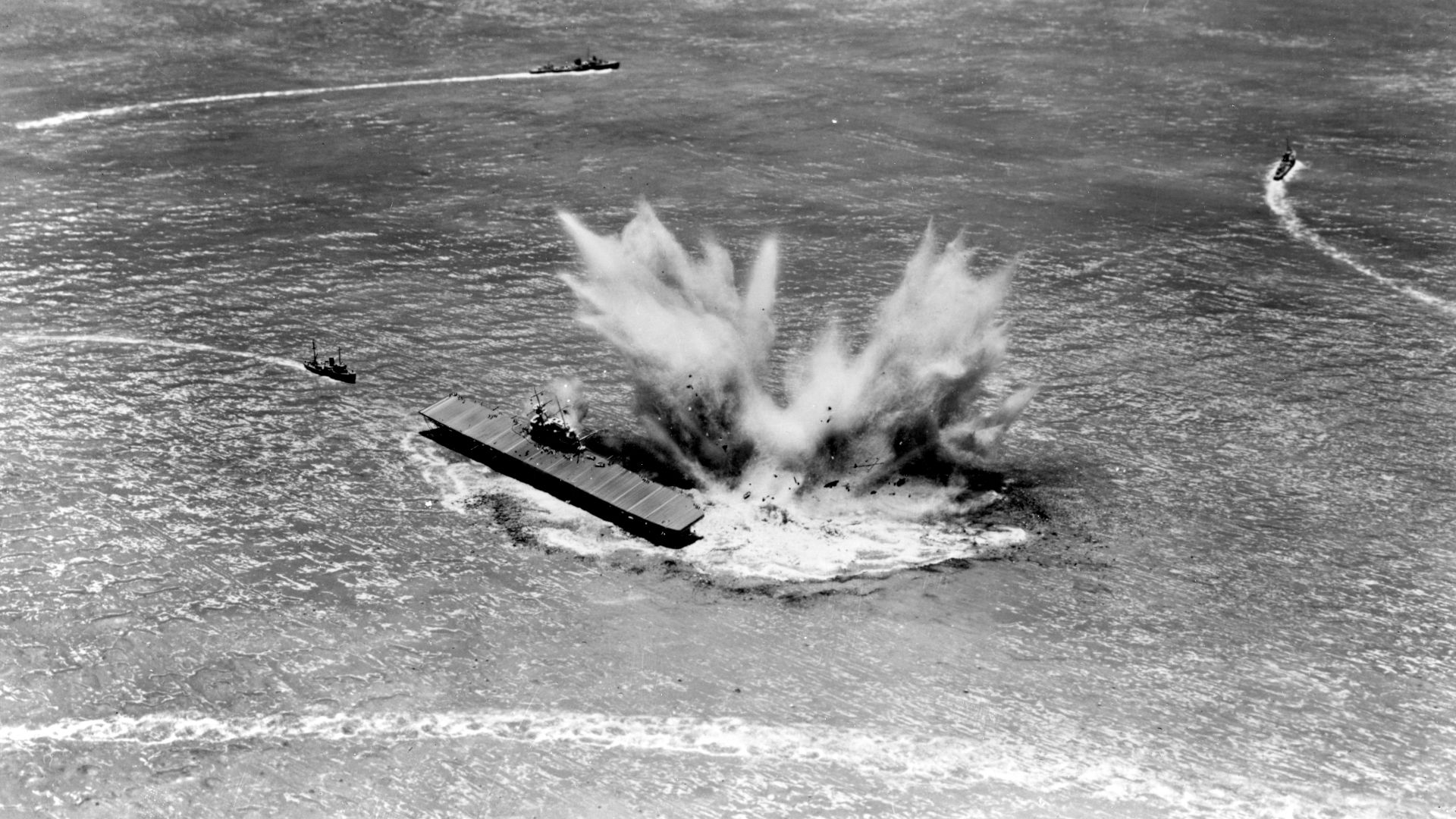 Diorama by Norman Bel Geddes, depicting the explosion of depth charges from USS Hammann (DD-412) as she sank alongside USS Yorktown (CV-5) during the afternoon of 6 June 1942. Both ships were torpedoed by Japanese submarine I-168 while Hammann was assisting with the salvage of Yorktown.

USS Vireo (AT-144) is shown at left, coming back to pick up survivors, as destroyers head off to search for the submarine.