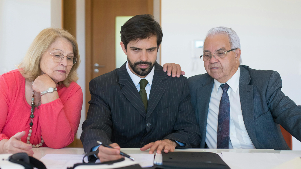 Realtor discussing contract with an elderly couple