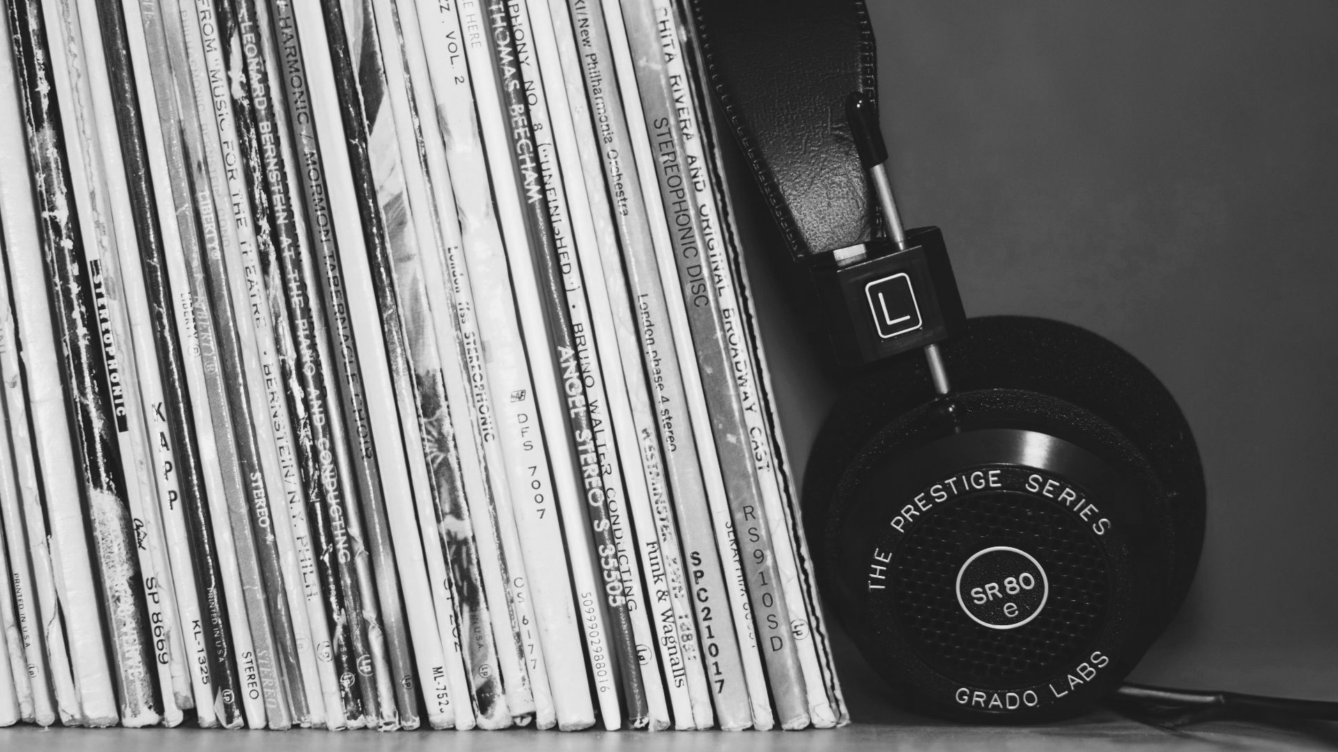 wireless headphones leaning on books