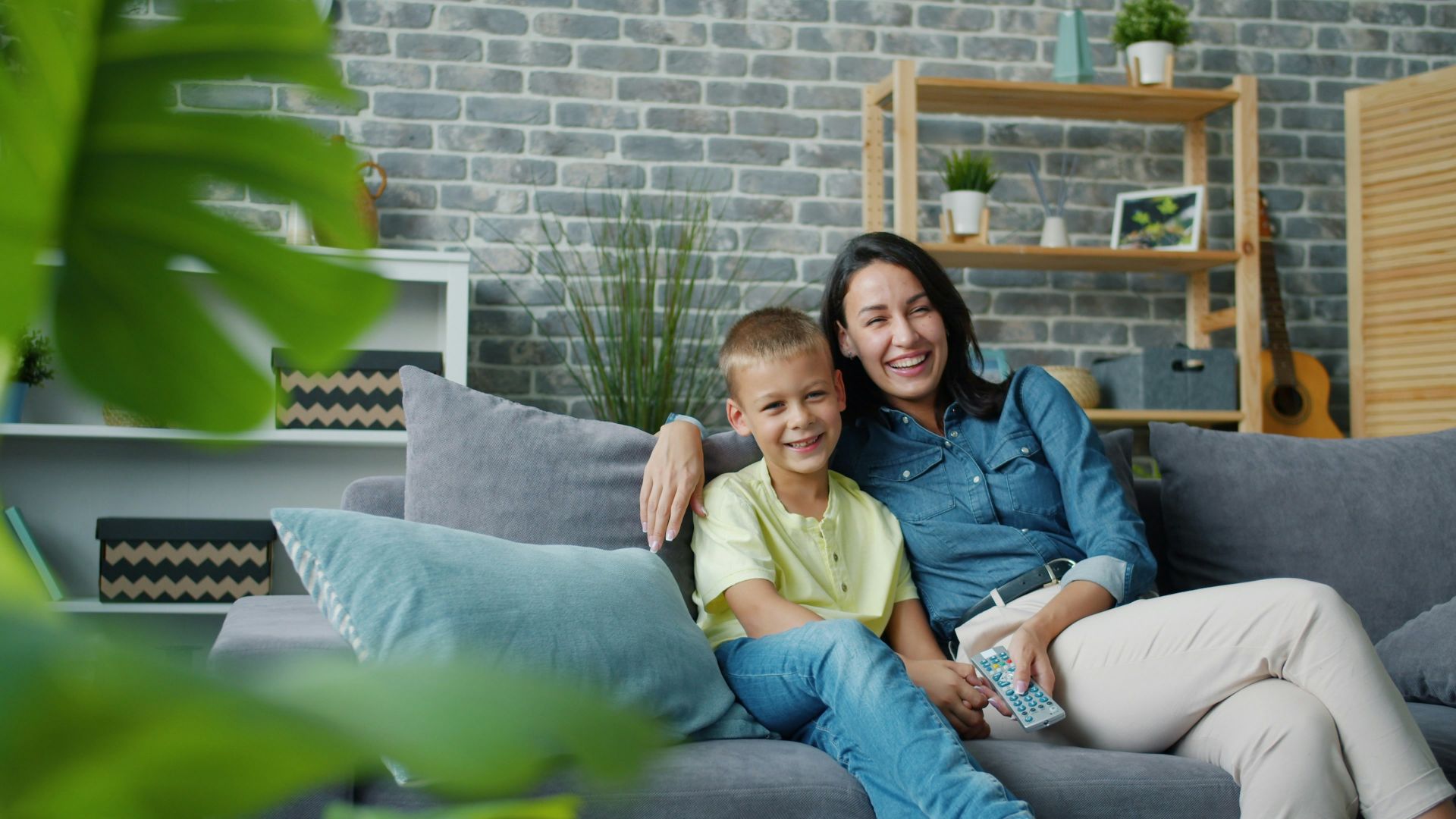 Mother and son smiling on a couch