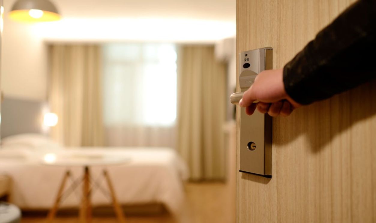 A soft-lit hotel room entrance, welcoming guests with luxury appeal and comfort.