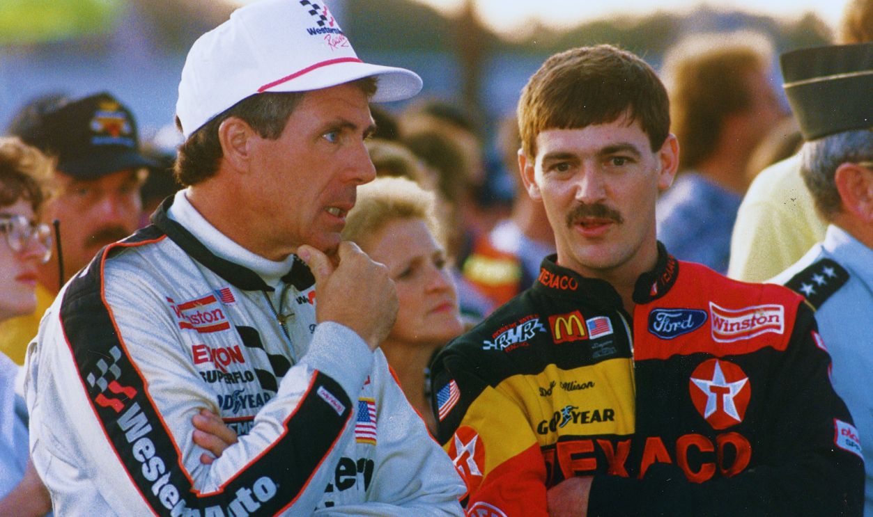 Gettyimages  - 137251051, DW-Davey Richmond 1992 RICHMOND, VA — September 12, 1992: Darrell Waltrip (L) talks with Davey Allison (R) before the start of the Miller Genuine Draft 400 NASCAR Cup race at Richmond International Raceway. 