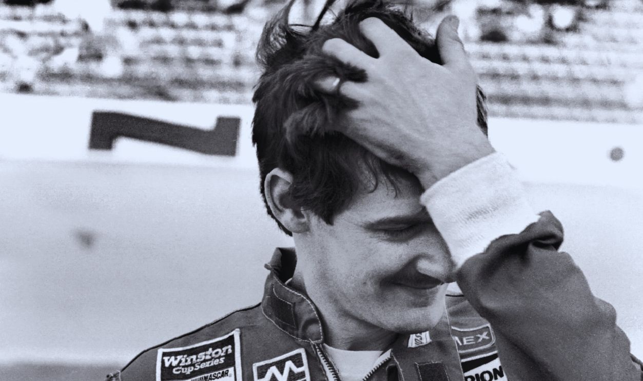 Gettyimages - 129592821, 1985 Daytona 500 DAYTONA BEACH, FL - FEBRUARY 16, 1985: NASCAR driver Davey Allison poses for photographers prior to the 1985 Daytona 500 at the Daytona International Speedway on February 16, 1985 in Daytona Beach, Florida.