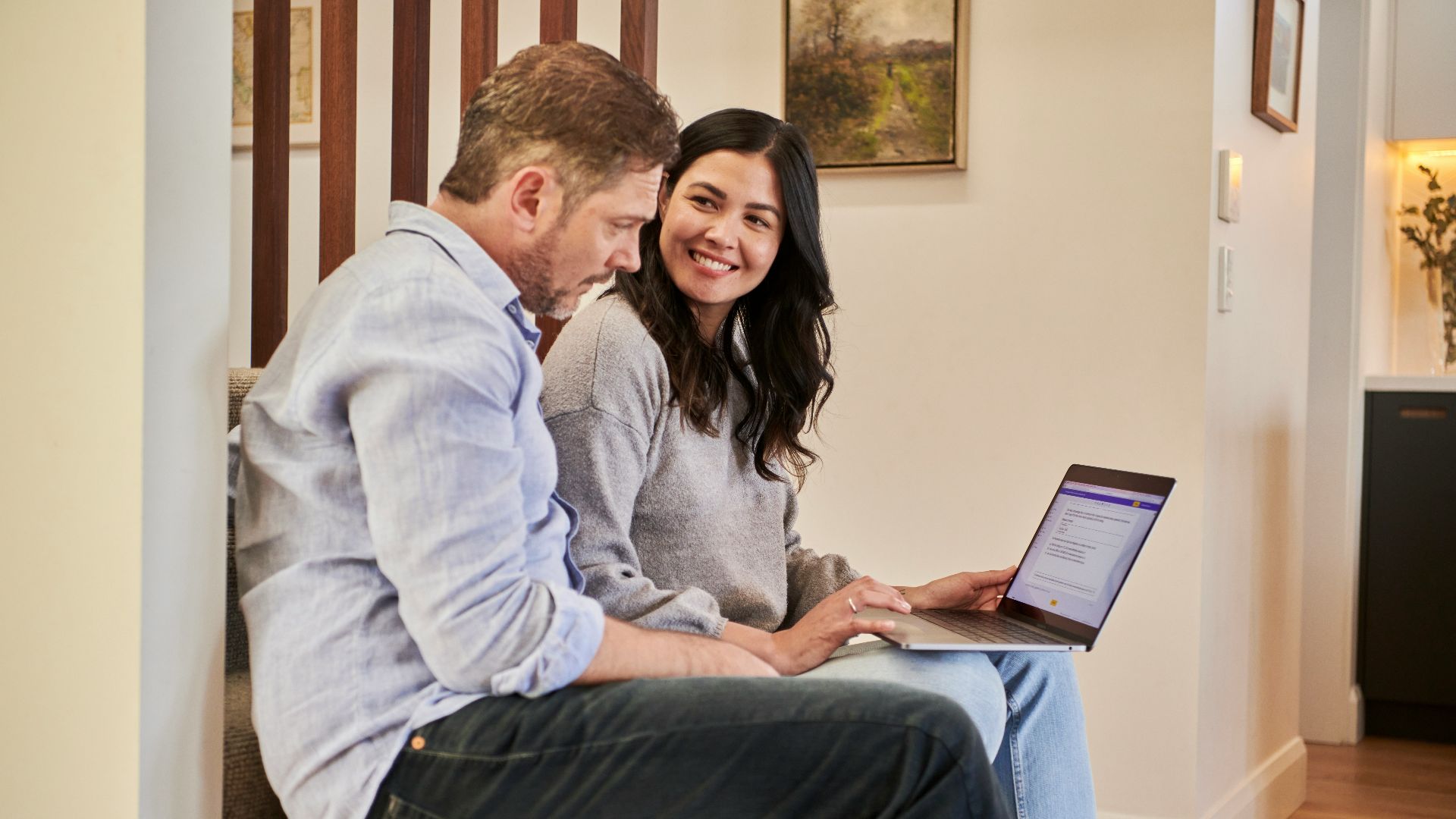 man sitting beside woman looking at a contract on DocuSign