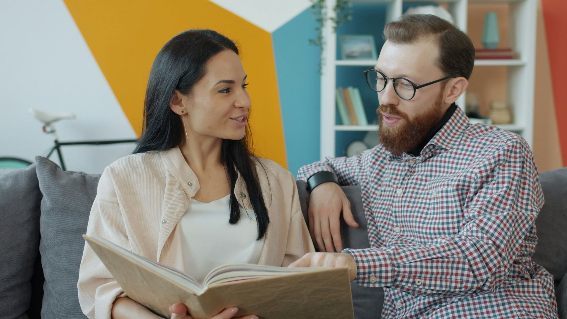 Couple looking at an open photo album together