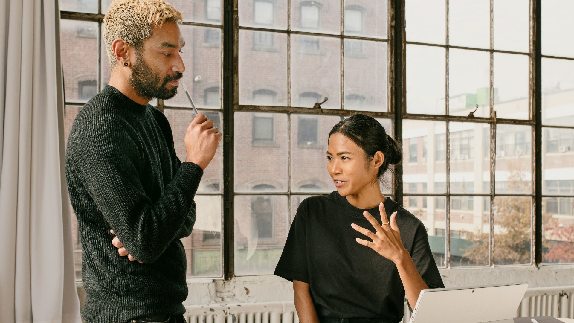 a man standing next to a woman at a table