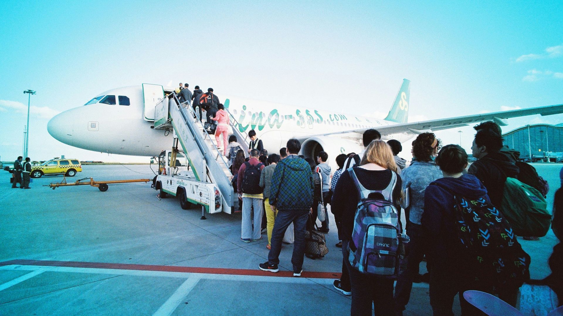 people about to enter plane during daytime