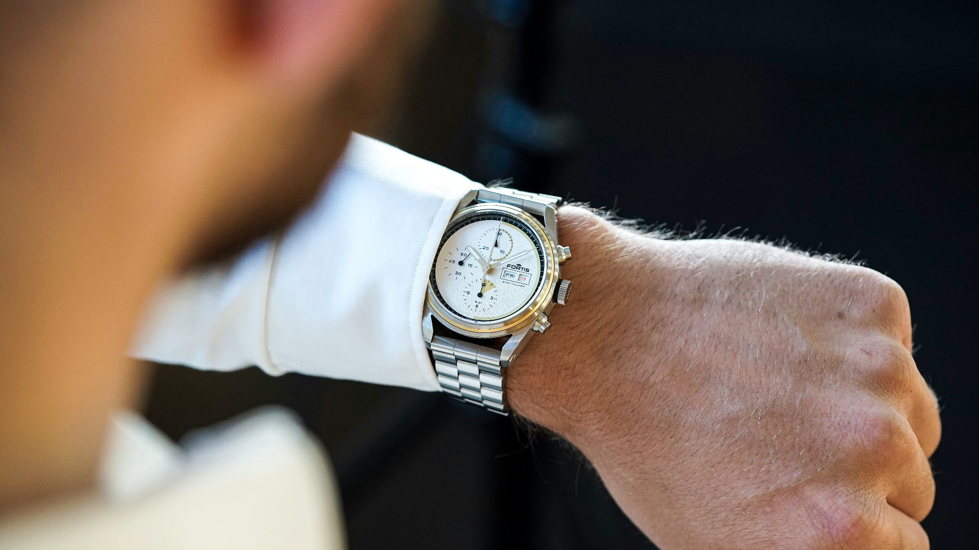 a close up of a person wearing a watch