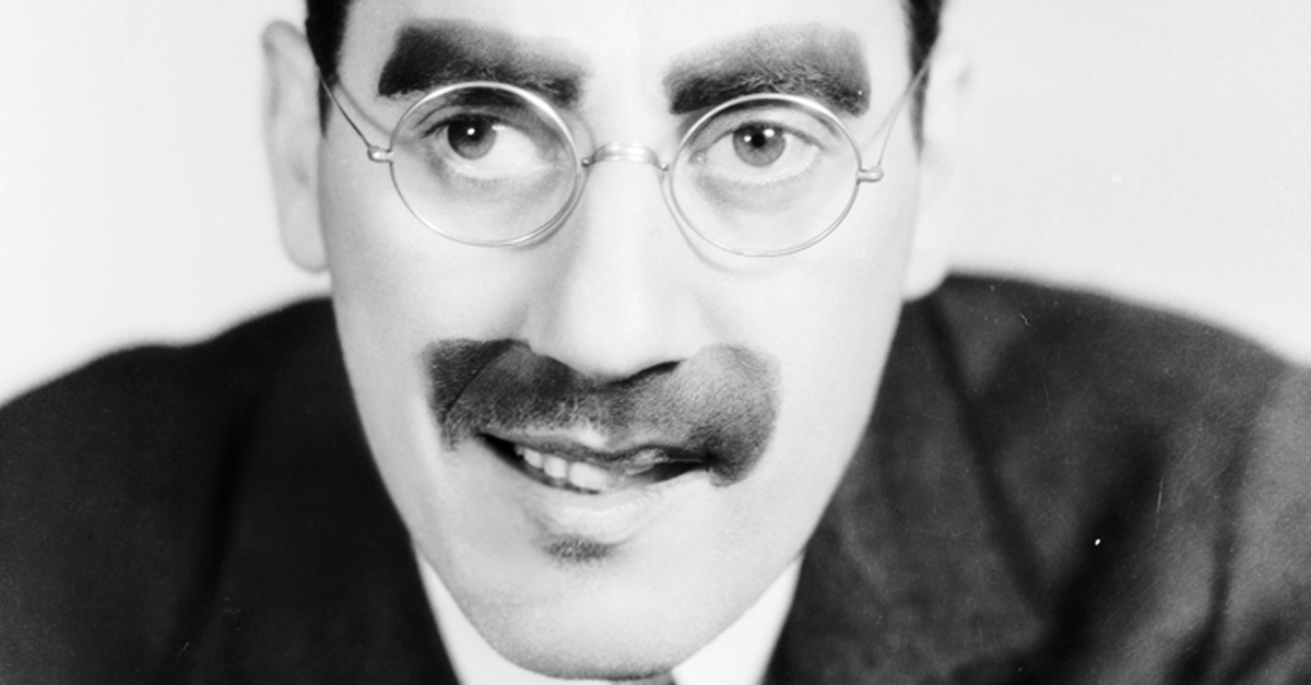 American actor Groucho Marx (1890 - 1977), with his trademark moustache and glasses.