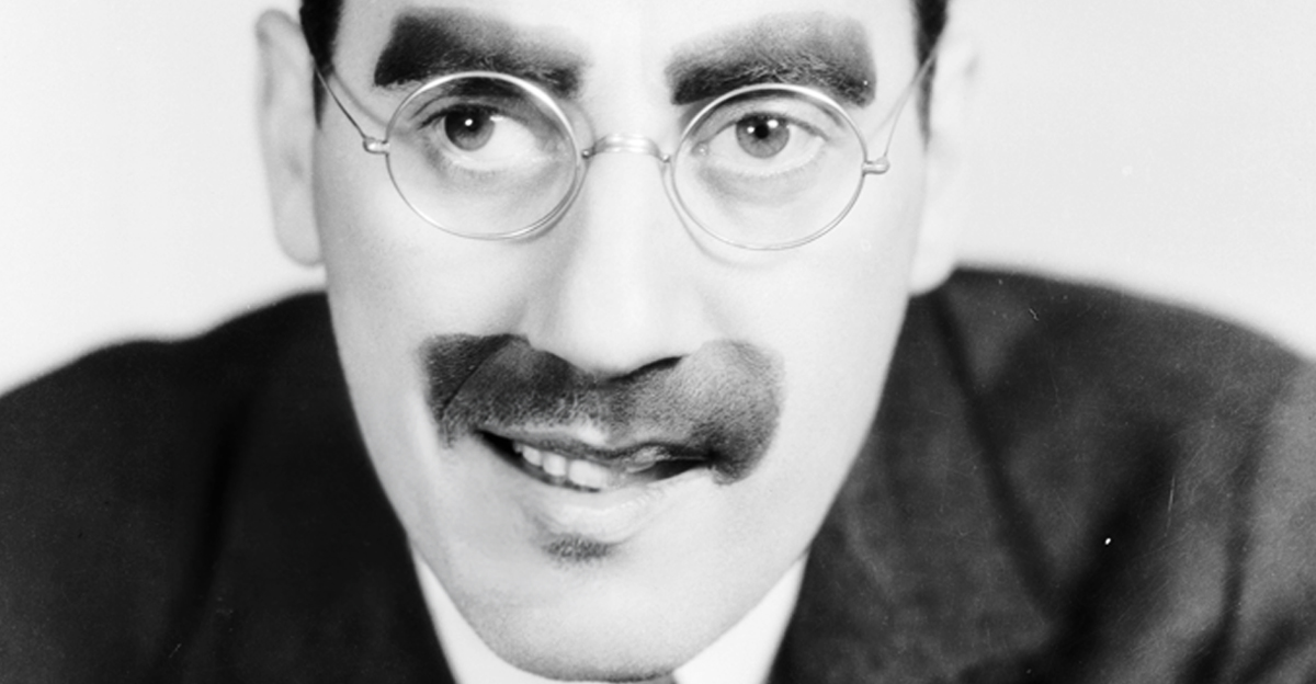 American actor Groucho Marx (1890 - 1977), with his trademark moustache and glasses. 