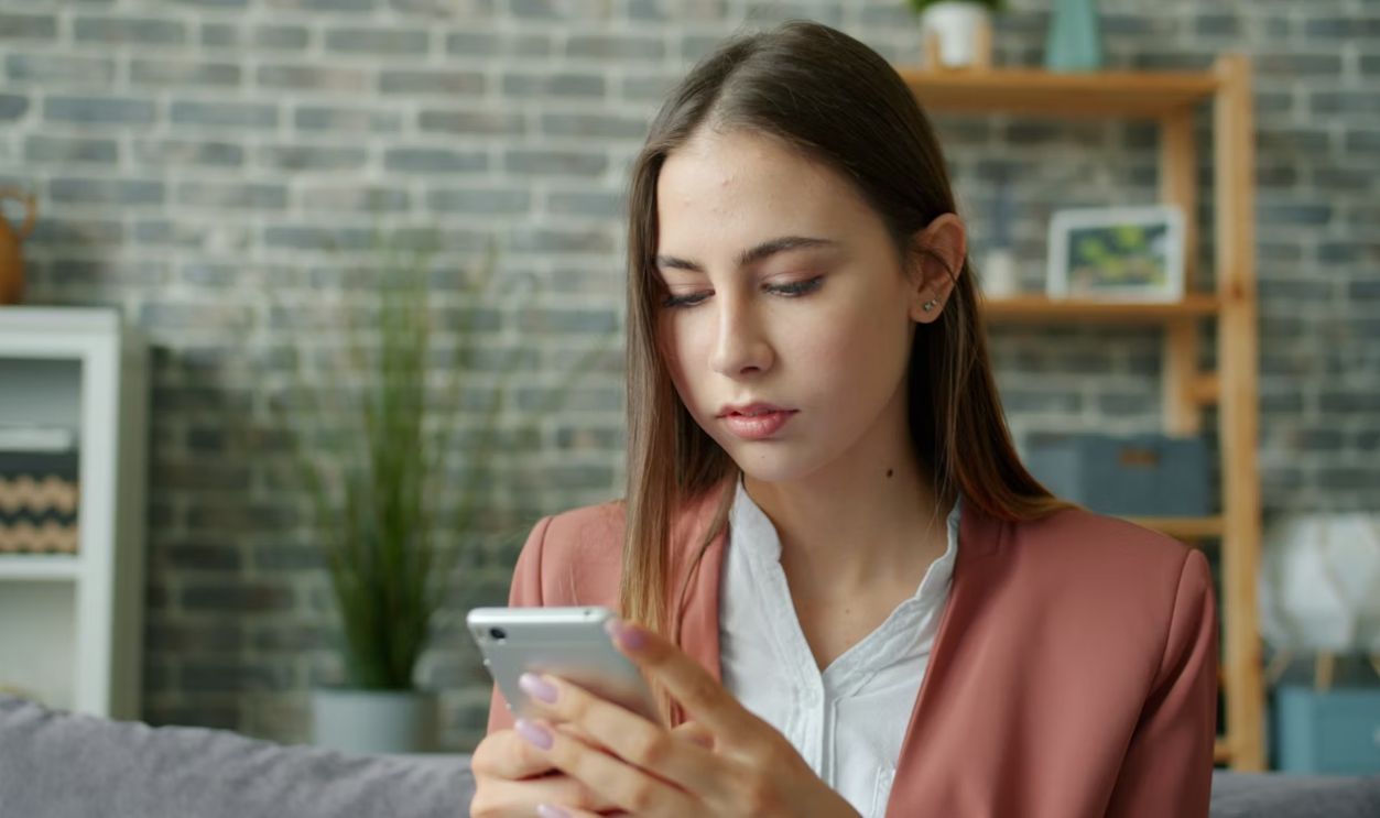 Young woman looking at her smartphone screen