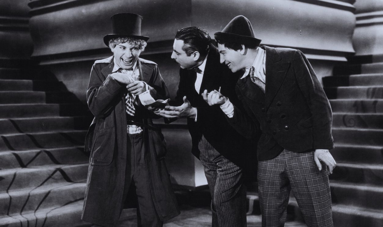 Gettyimages - 121647644, Harpo Marx, Zeppo Marx And Goucho Marx In 'Animal Crackers' Harpo Marx in a top hat with Zeppo and Groucho Marx looking at him in a scene from the film 'Animal Crackers', 1930. 