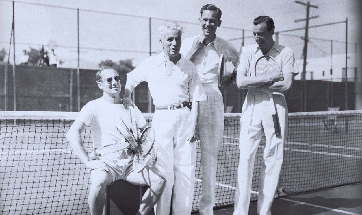 Gettyimages - 517298116, Charlie Chaplin Posing with Colleagues (Original Caption) Tennis Foursome. Beverly Hills, California: In one of the dizziest tennis matches seen for quite a spell, Groucho Marx and Ellsworth Vines teamed up to play Charlie Chaplin and Fred Perry in Beverly Hills, Calif., recently. It was never decided who won, but the boys has a grand time. Left to right: Marx, Chaplin, Vines and Perry. 