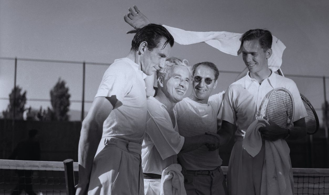 Perry and Charlie Chaplin defeated Ellsworth Vines and Groucho Marx, as part of the ceremonies opening the exclusive Beverly Hills Tennis Club, at Beverly Hiss, California. 