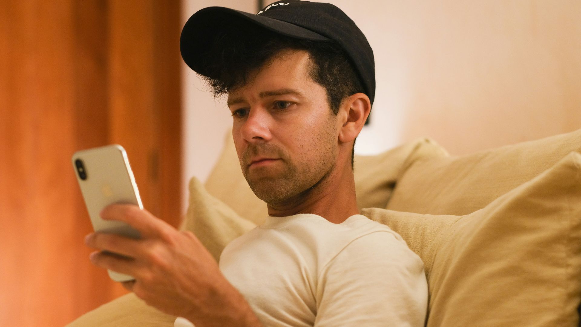 A man is focused on his phone.