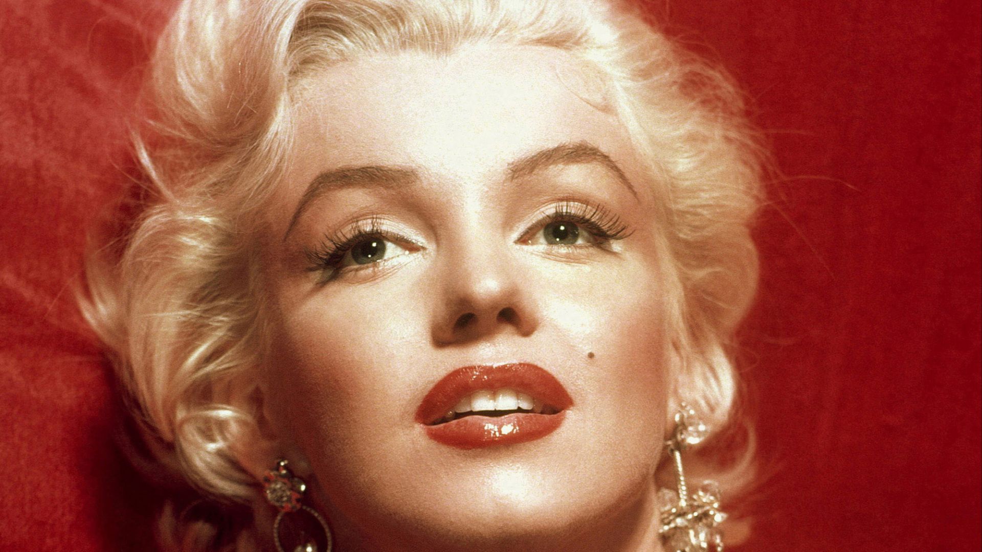 A glamorous Marilyn Monroe in a red dress, taken for publicity purposes for 1953 film How to Marry a Millionaire.