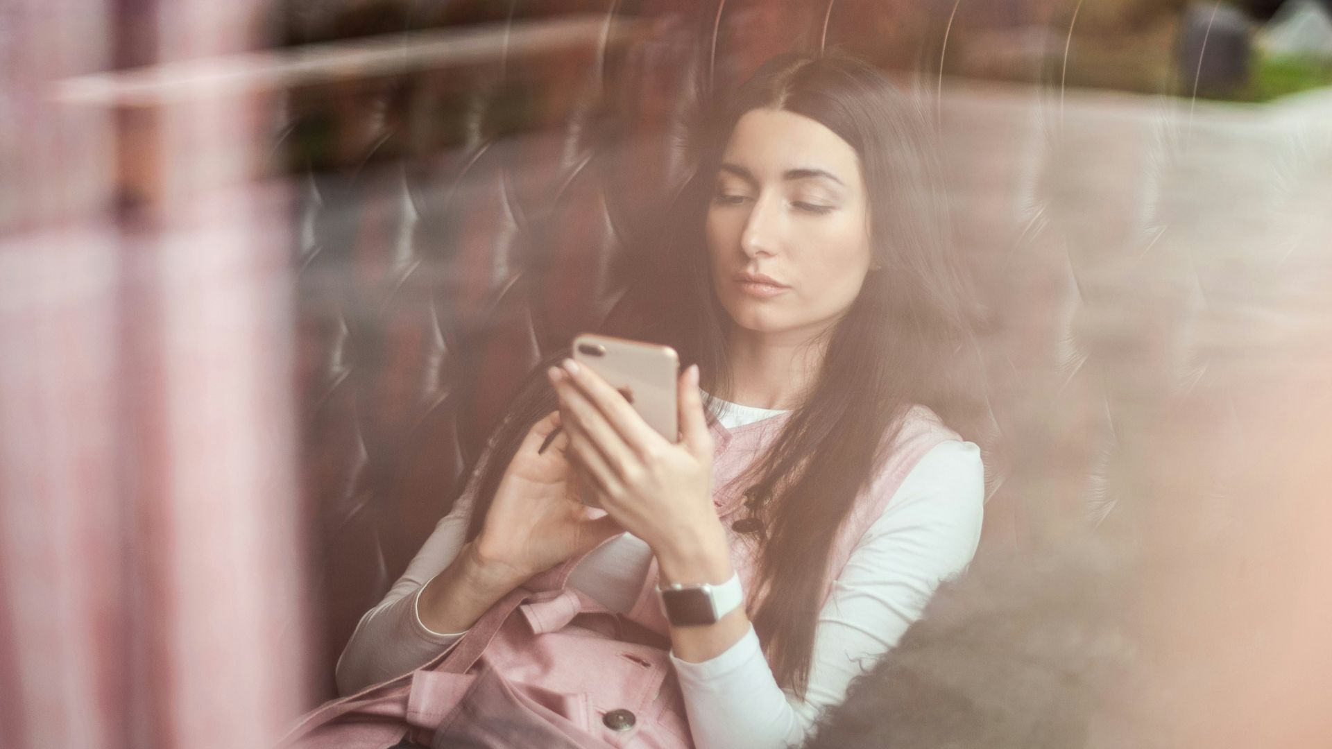 woman in white long sleeve shirt holding gold iphone 6
