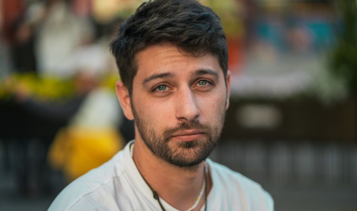 A man is looking directly at the camera