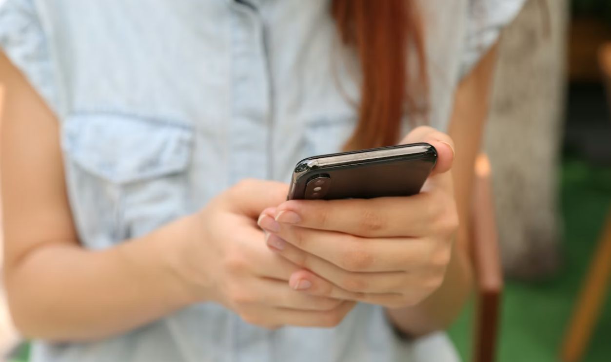 person holding using iPhone X