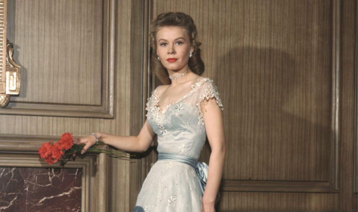 Vera-Ellen portrait posing by mantle circa 1947. 
