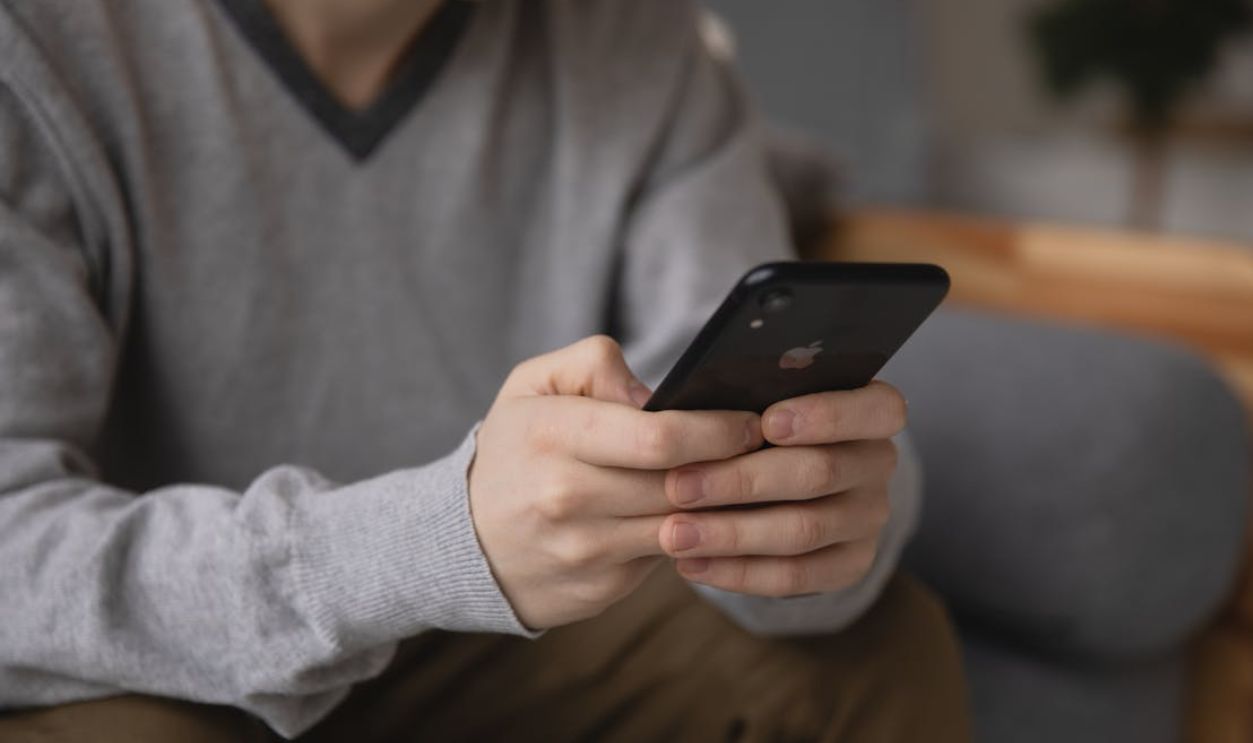 Person holding a smartphone, focusing on connectivity and modern technology