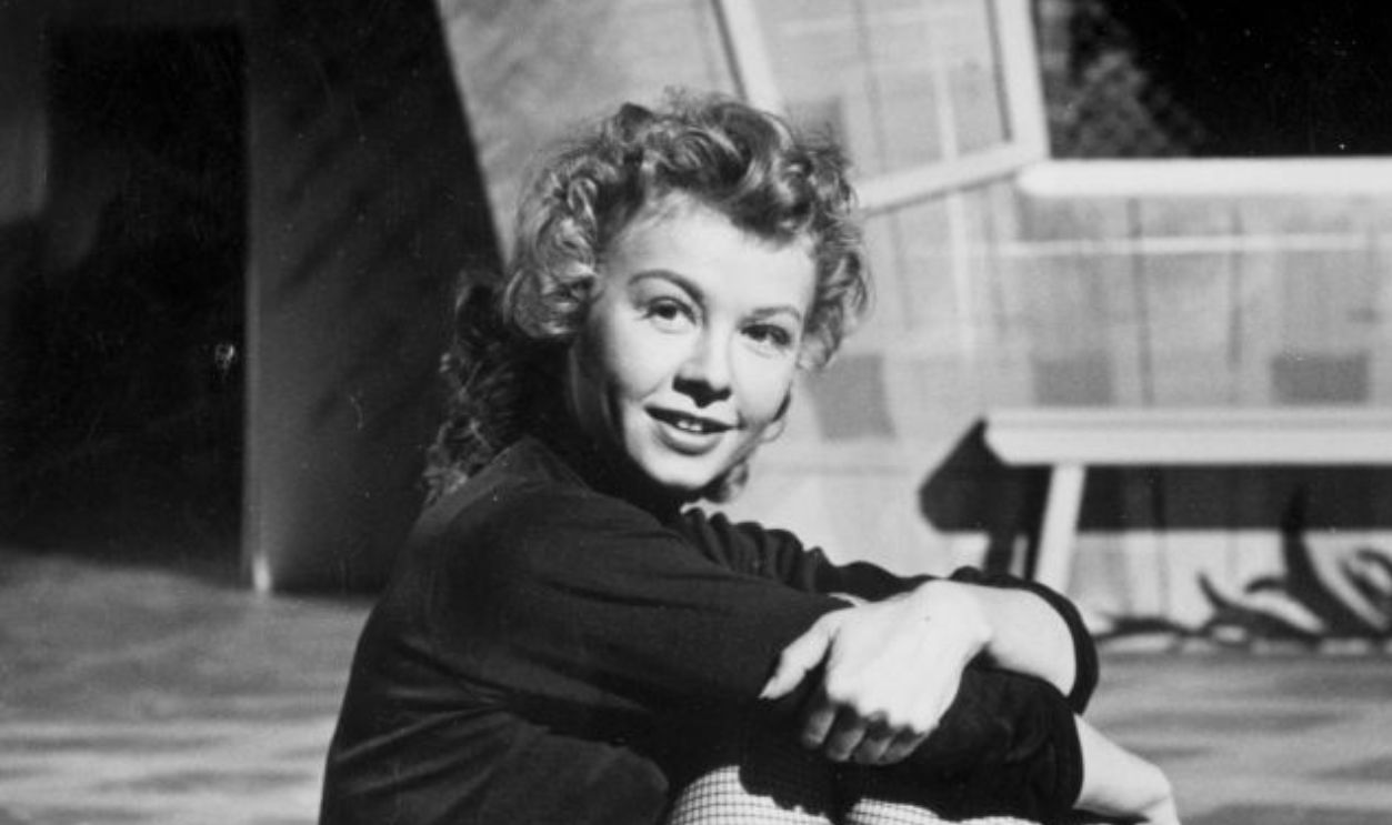 8th July 1950: American dancer Vera-Ellen (1920 - 1981) resting between rehearsals for the N P Rathvon musical 'Happy Go Lovely' at Elstree studios. Original Publication: Picture Post - 5081 - The Girl Who Hit Town - pub. 1950 