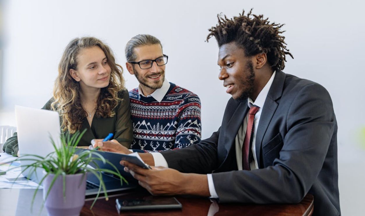 A diverse group of professionals collaborating in an office meeting, showcasing teamwork and partnership.