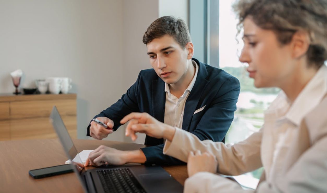 Professional businesspeople discussing work at a modern office table.