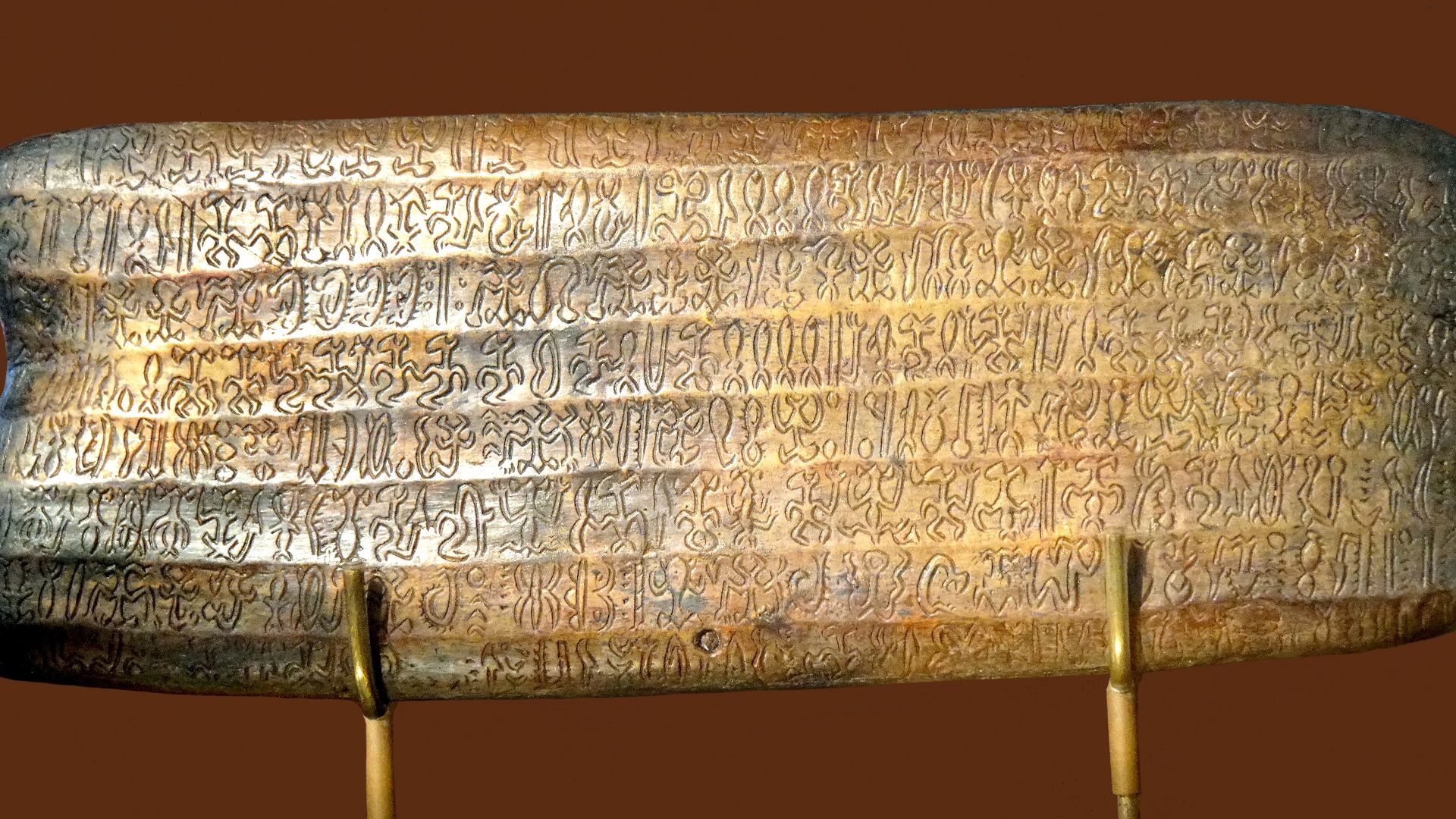 A reproduction of a rongorongo tablet, known as the 'Small Santiago' (text G), verso, at MAPSE Museum Rapa Nui in Hanga Roa, on Easter Island. 
Rongorongo inscriptions, this is a copy of the tablet called Mu'a Au Mingo Ata'i Hoa Au. It has 16 lines (8 on 