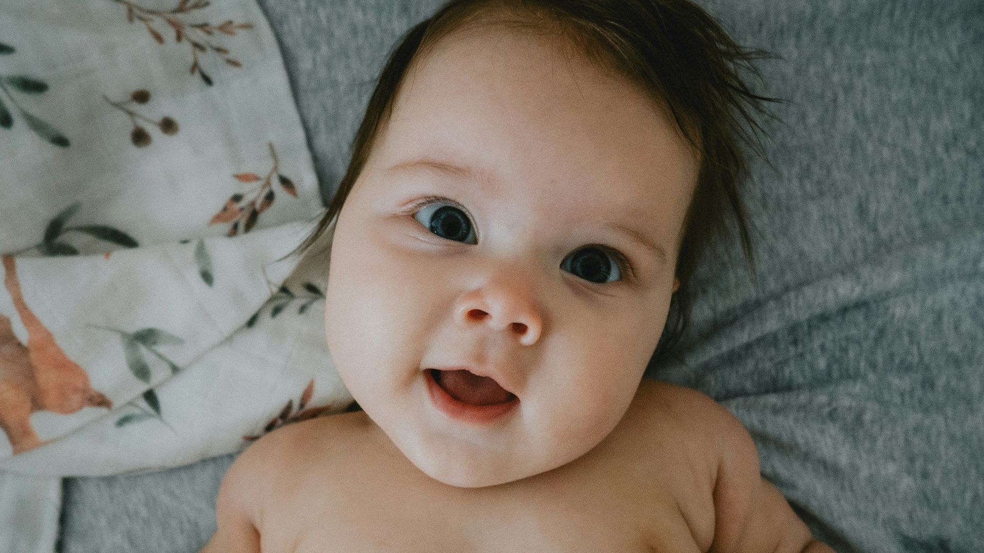 a hand holding a baby