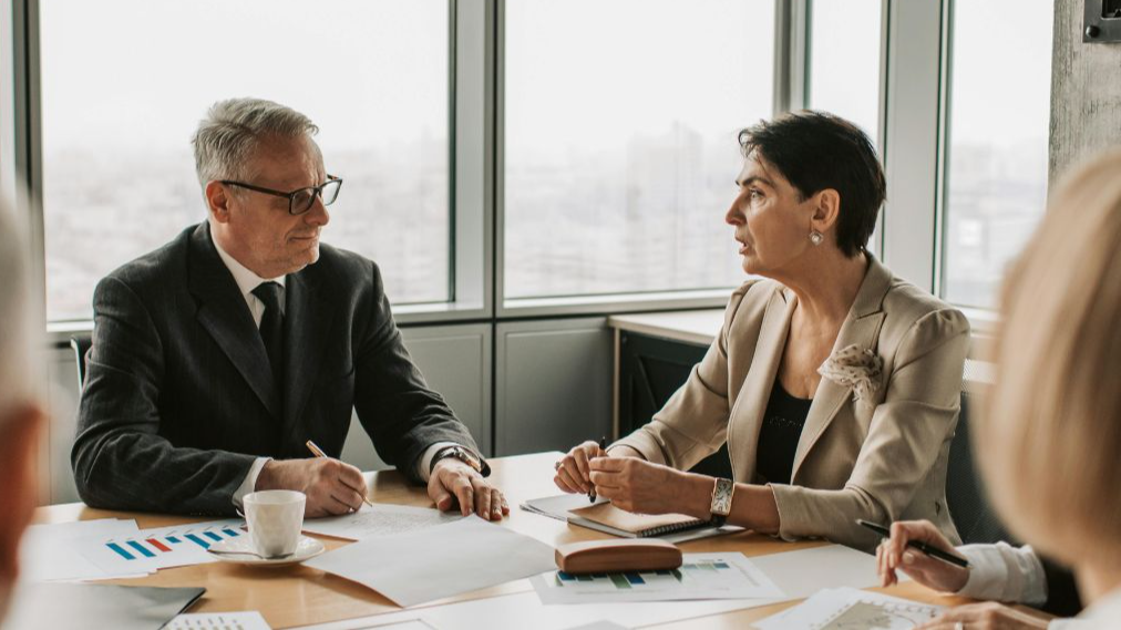 Man and woman discussing business in a meeting