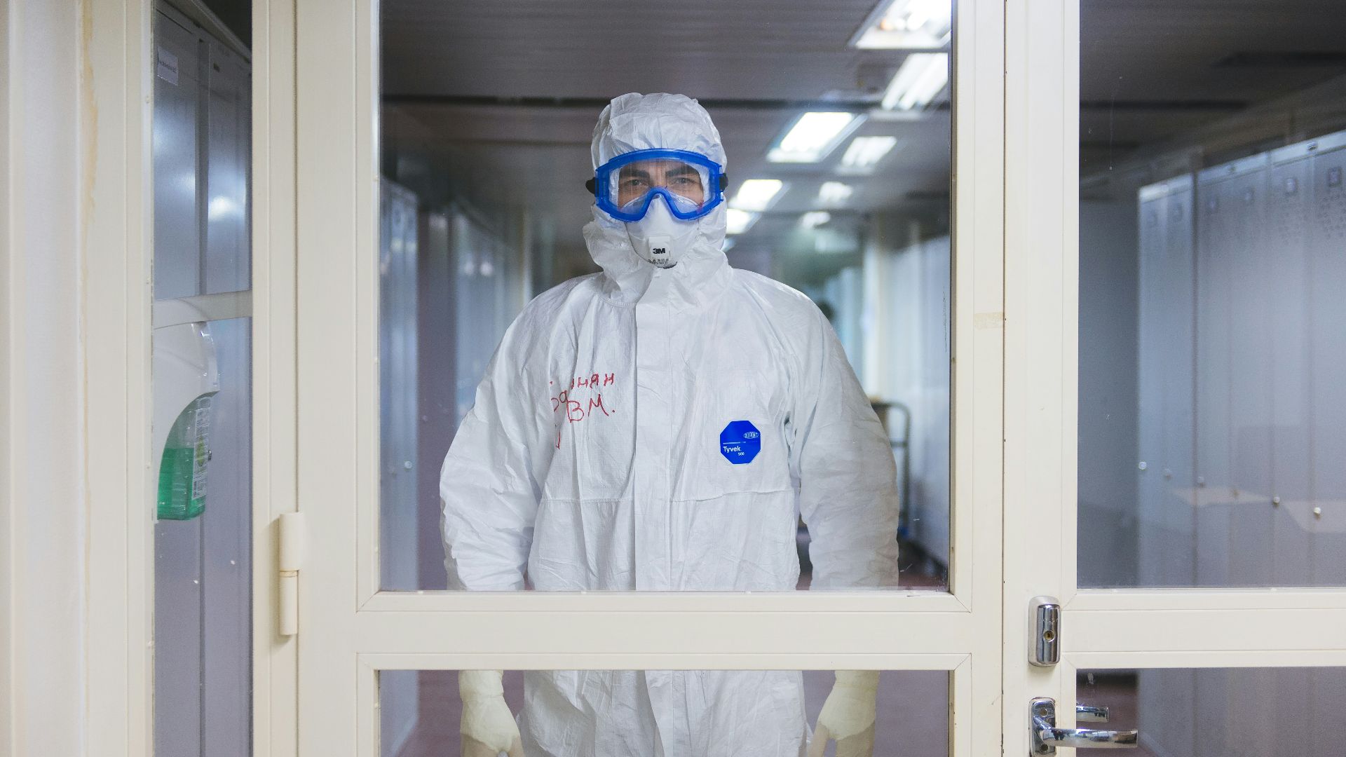 person in white jacket wearing blue goggles