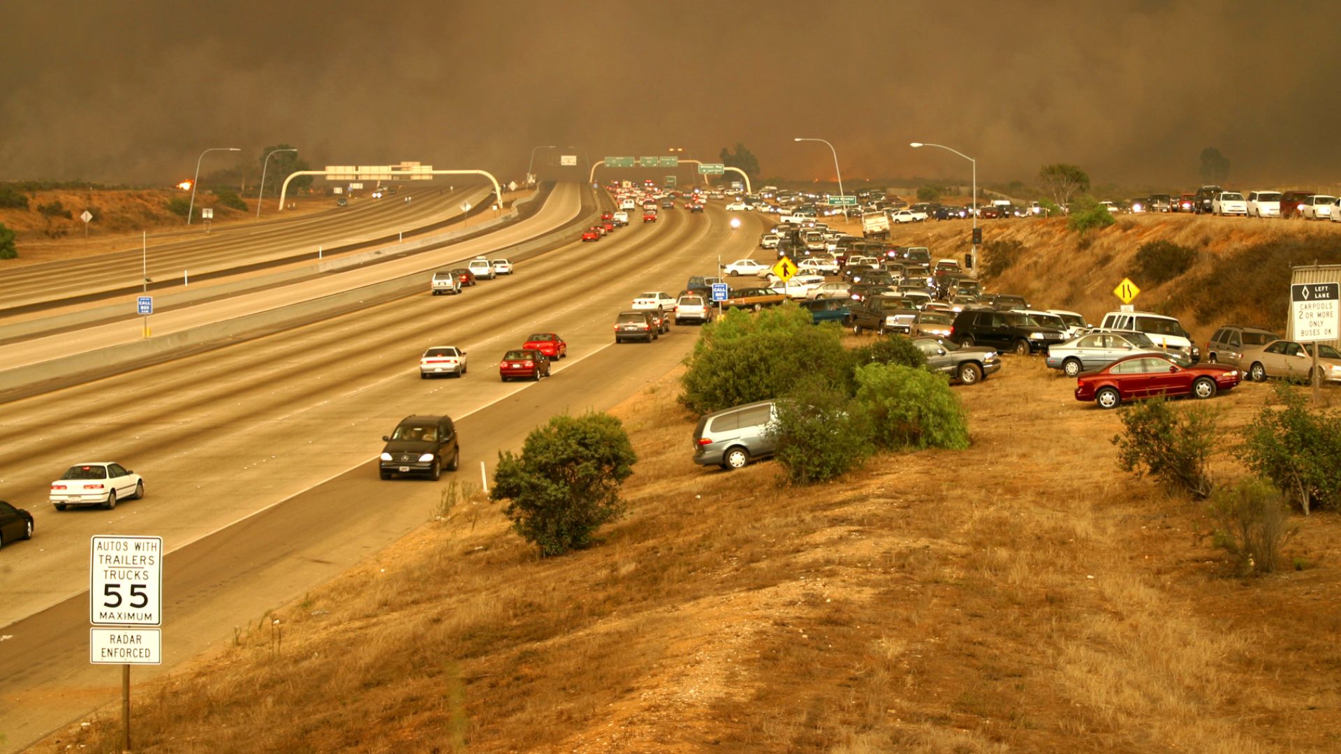 Miramar, Calif.  (Oct. 26, 2003) -- Cars scramble to exit the freeway by driving up the embankment to the on ramp, and moving against the flow of traffic in an effort to flee the flames as the Cedar fire crosses the I-15 freeway onto Marine Corps Air Stat
