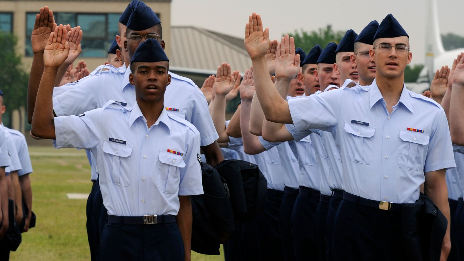 Basic trainees raise their right hand April 24 as they recite the oath of enlistment at Lackland Air Force Base, Texas.